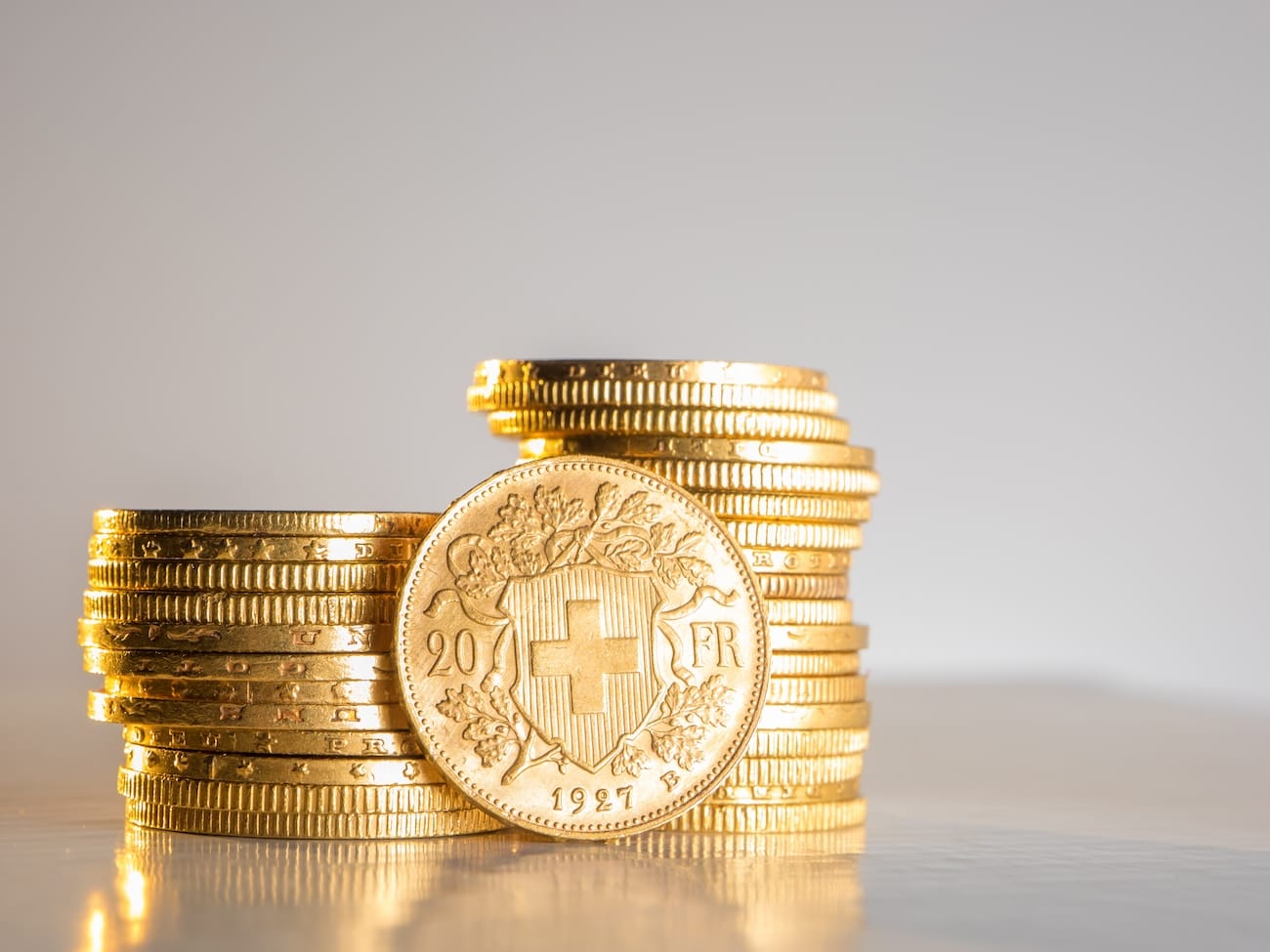 A stack of twenty Swiss Franc coins, symbolizing the security of the Swiss Franc and the protection offered by esisuisse.