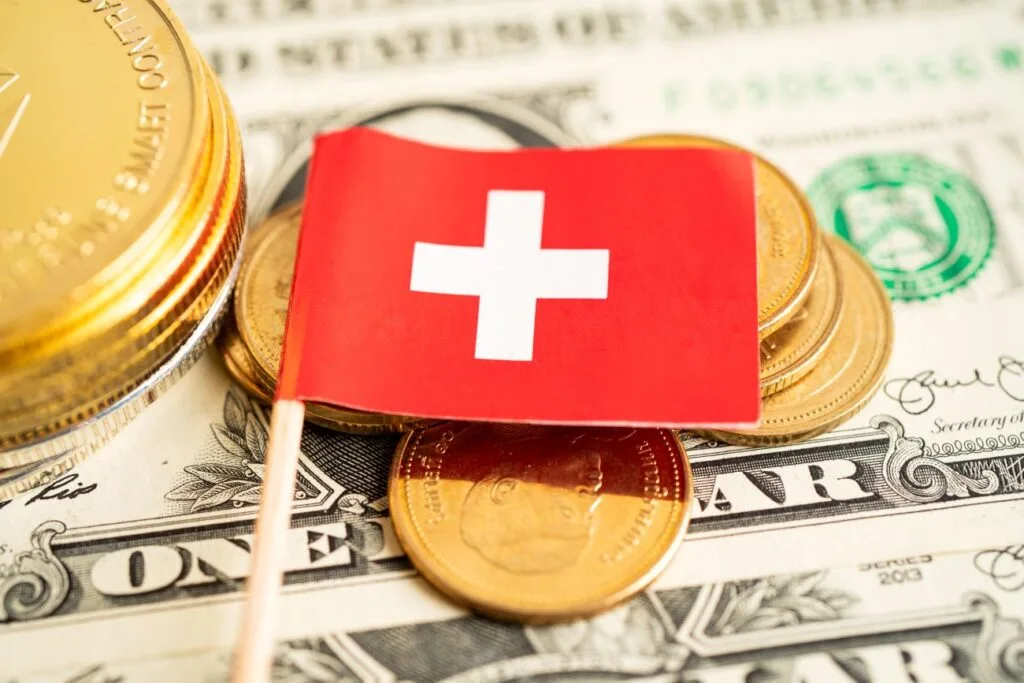 Stack of coins with Switzerland flag illustrating tax considerations for clients of Swiss banks and financial planning strategies