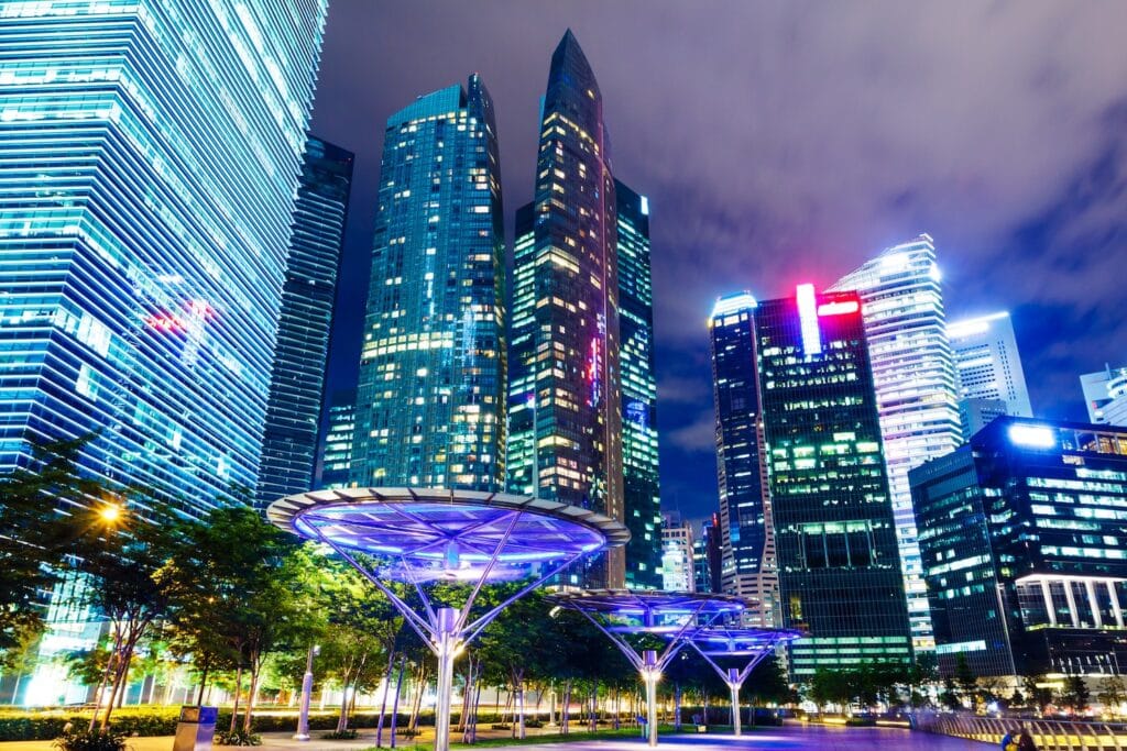 Futuristic night view of Singapore's financial district skyline, representing the advanced ecosystem for cryptocurrency banking in Singapore for non-residents.