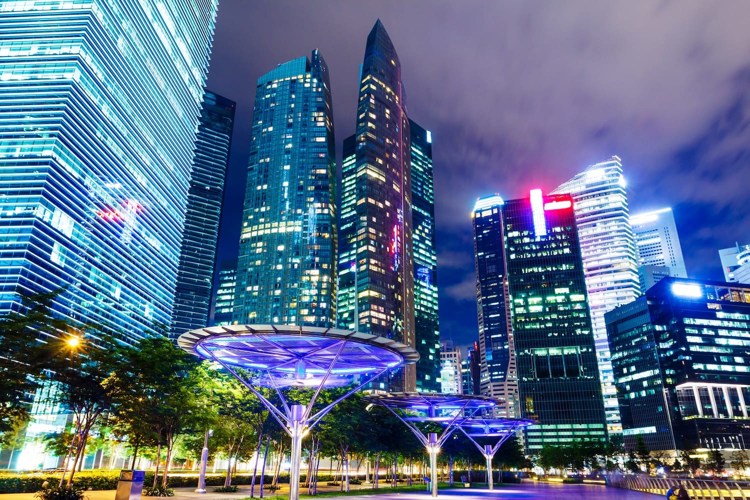 Futuristic night view of Singapore's financial district skyline, representing the advanced ecosystem for cryptocurrency banking in Singapore for non-residents.