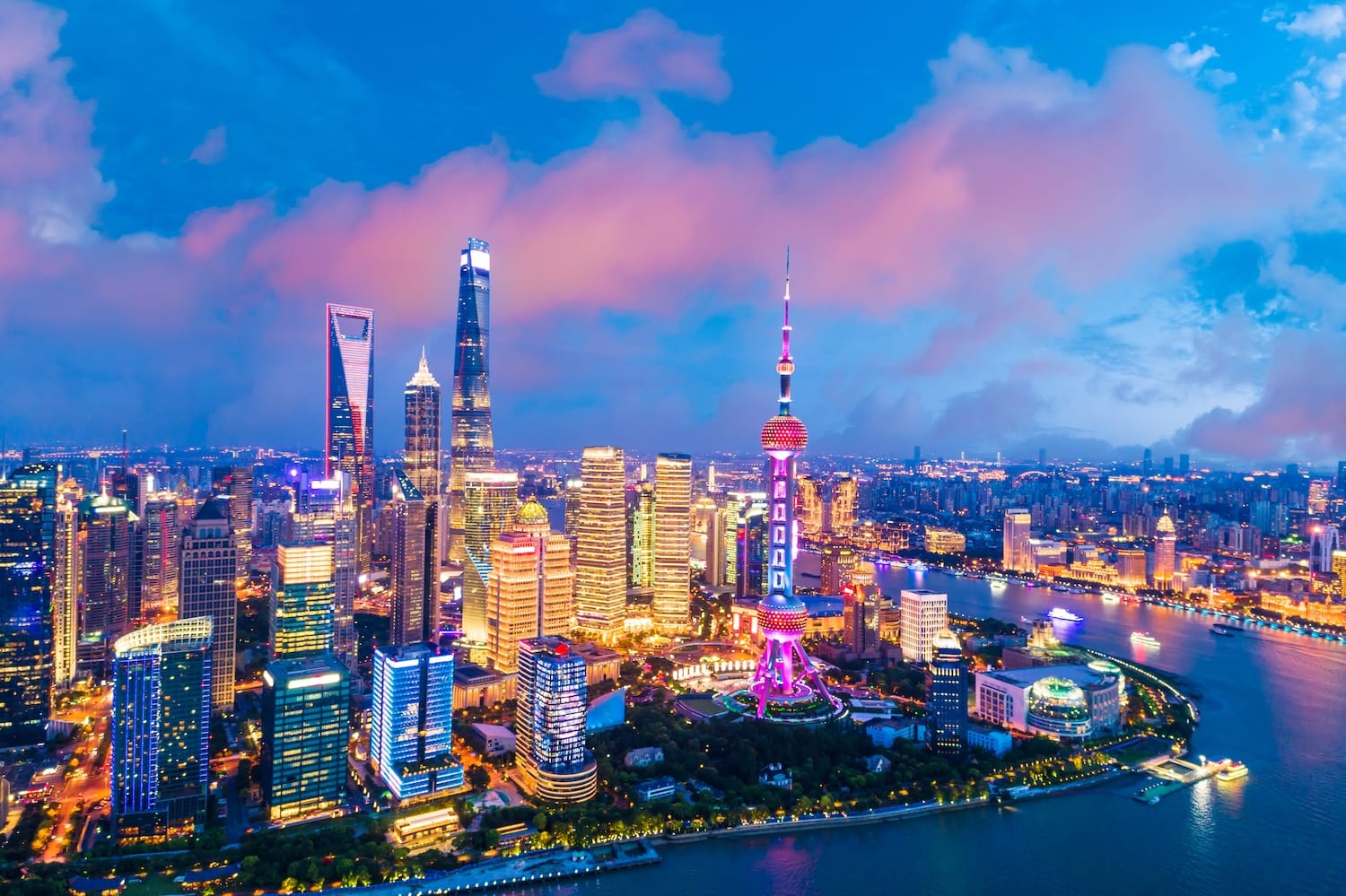erial view of the illuminated Shanghai skyline at dusk, illustrating the financial landscape for a Swiss bank account for Chinese mainland nationals compliance.