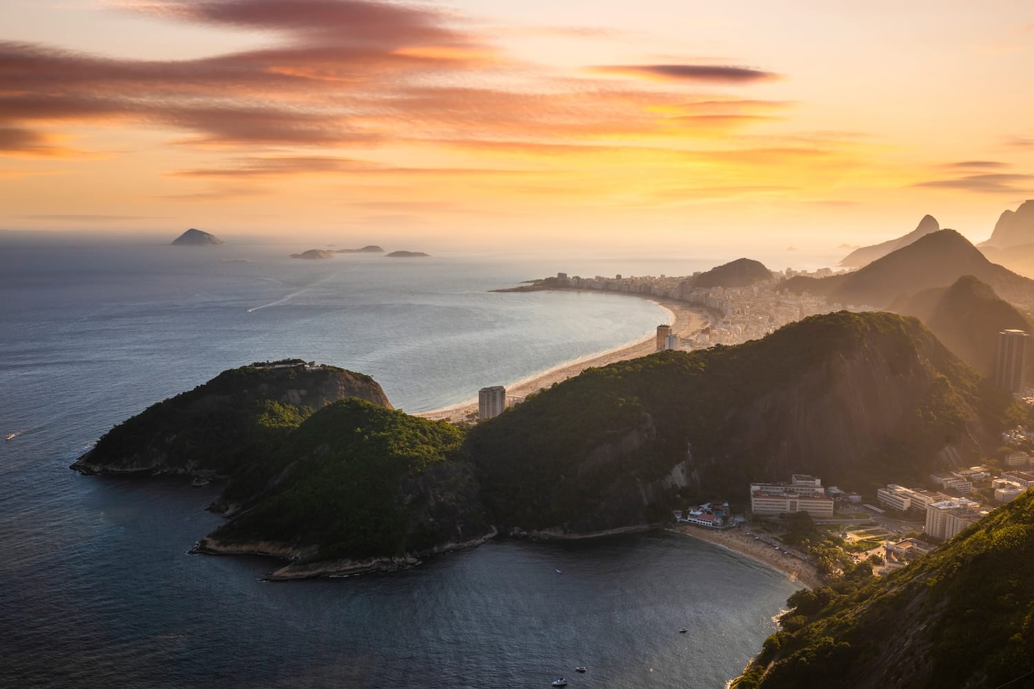 Aerial view of the Rio de Janeiro coastline at sunrise, symbolizing the wealth management landscape of Swiss offshore banking for Brazilian nationals under FATCA and CRS regulations.