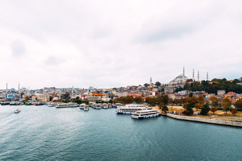 Panoramic waterfront view of Istanbul skyline with mosques and boats, illustrating cross-border finance and legally moving money from Turkey to a Swiss bank account