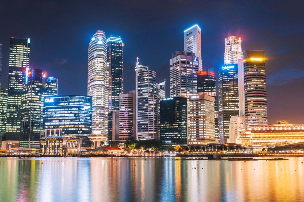 Night view of the Singapore skyline featuring headquarters for a list of banks in Singapore located in the Financial District.