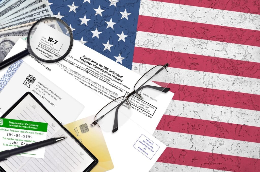 IRS Form W-7 Individual Taxpayer Identification Number application with ITIN card showing 999-99-9999, US dollar bills, and American flag — offshore wealth management compliance documentation for US persons