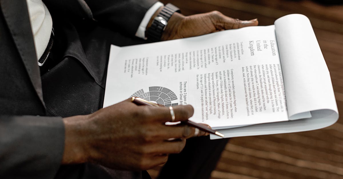 Business professional reviewing financial documents with charts and graphs during a meeting.