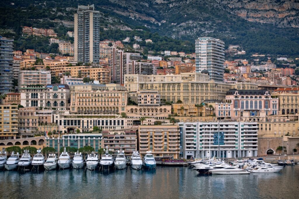 A panoramic view of Monte Carlo’s iconic harbor filled with luxury yachts and upscale architecture, representing the premier financial environment for those looking to open a bank account in Monaco.